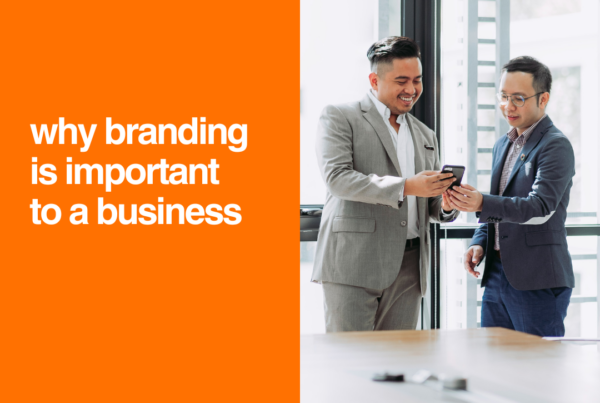 A business professional reviewing brand design elements, including a logo, color palette, and marketing materials, to create a strong and recognizable brand identity